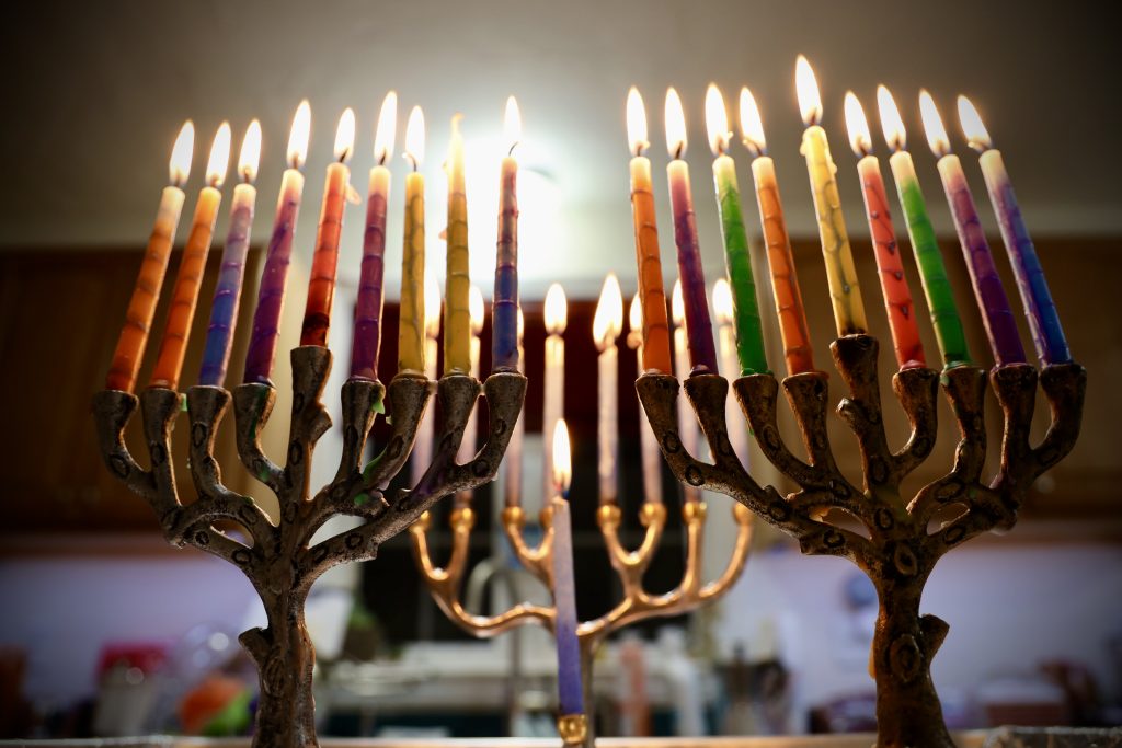 Three Chanukah menorahs fully lit